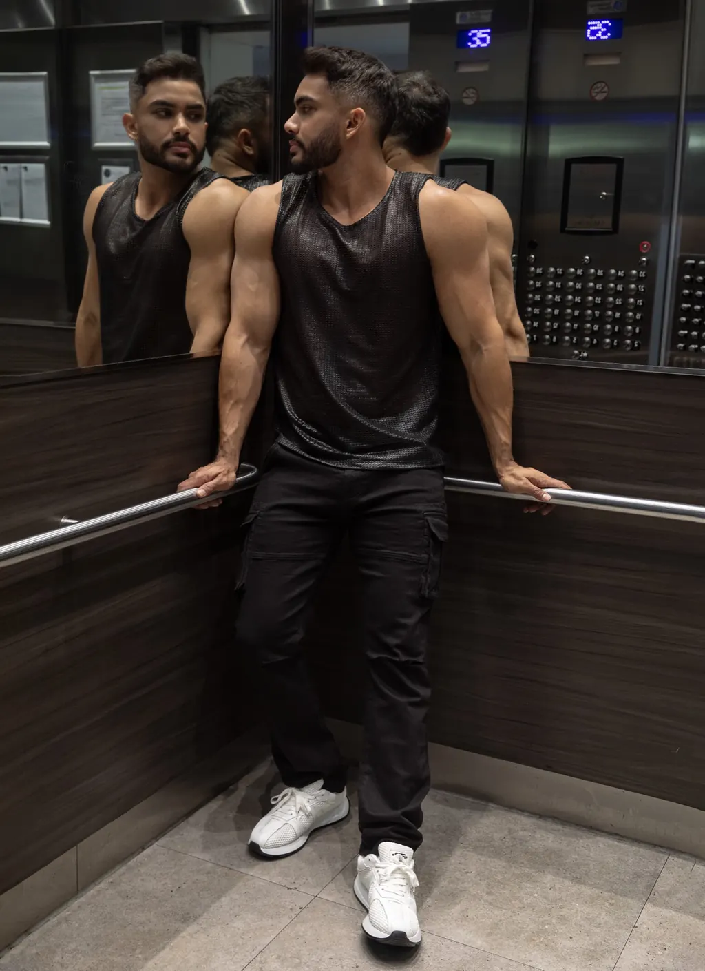 ES Collection model in a dark sleeveless top and black trousers